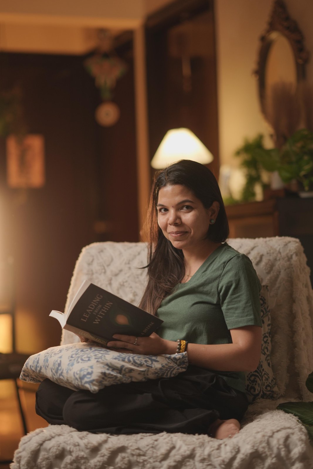 Anamika, smiling with a book