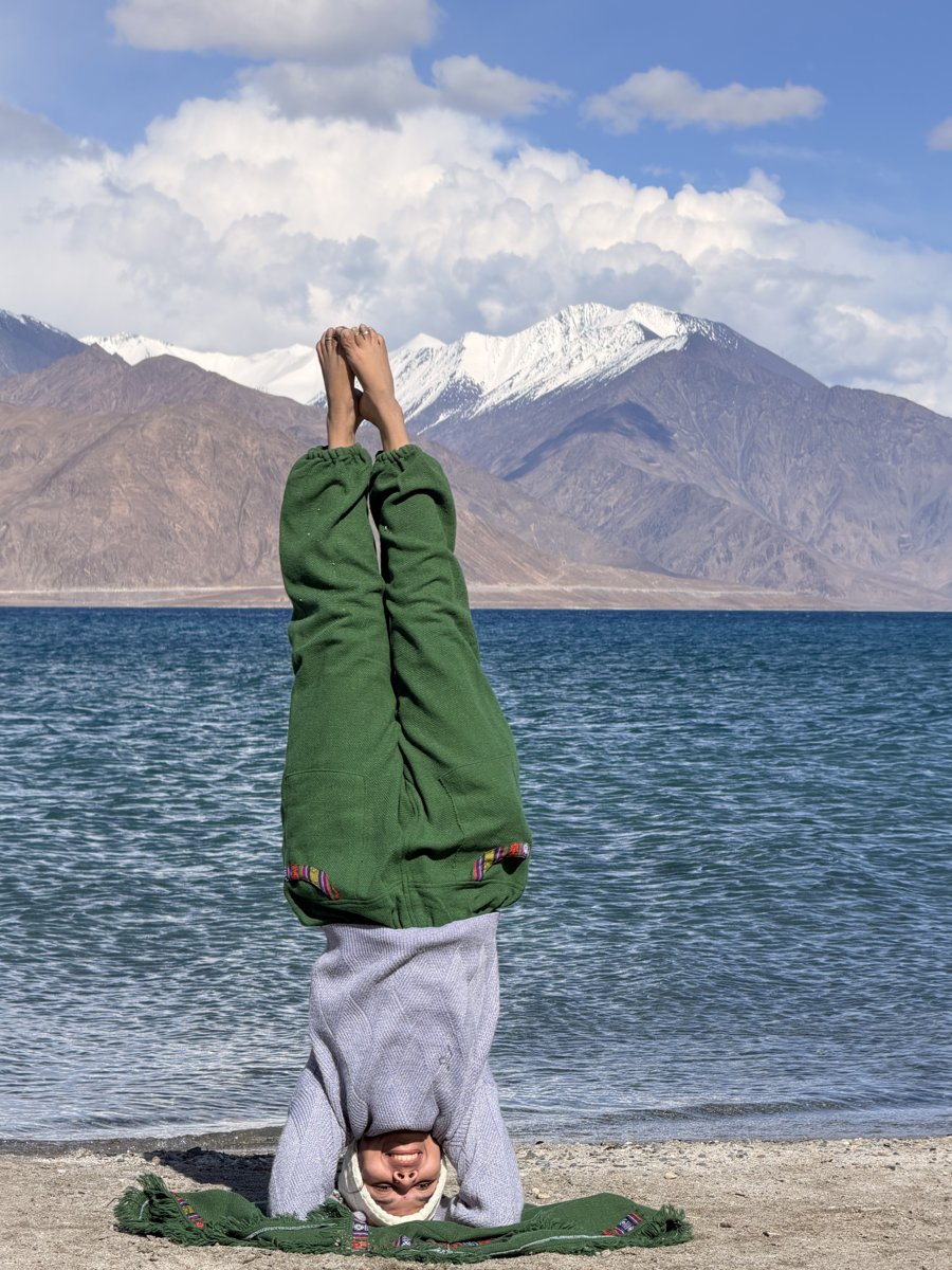 Anamika's yoga practice by a mountain lake